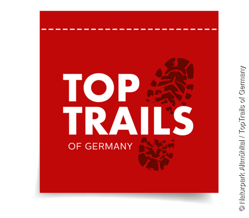 Das Logo besteht aus einem schwarzem Schuhabdruck und in weiß steht TopTrails of Germany auf rotem Hintergrund.